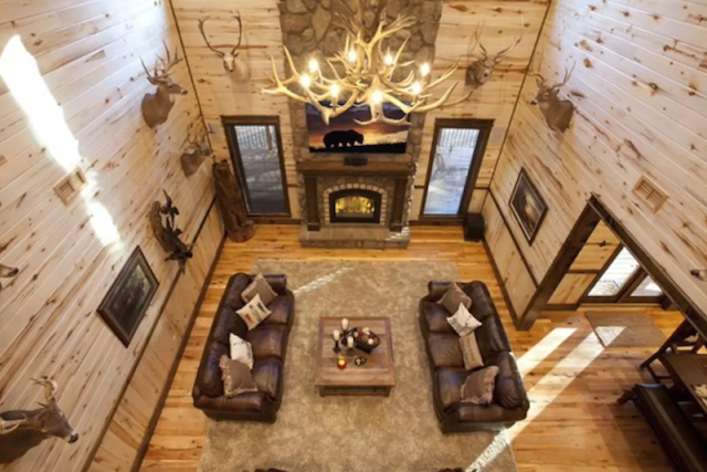 interior sitting room with fireplace in luxury cabin in broken bow