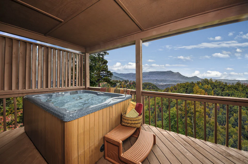 cabin porch with hot tub and an amazing view of the surrounding area